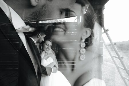 beautiful couple hugging outdoors in wooden hut, multiexpositionの写真素材