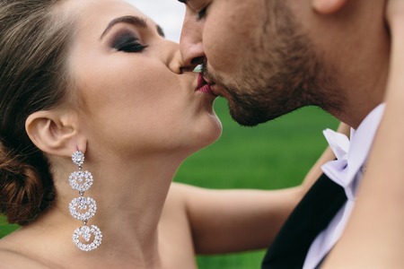 Beautiful wedding couple is walking on the green fieldの写真素材
