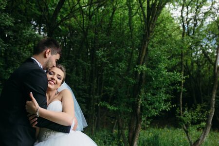 beautiful young couple posing in the forest from close angleの写真素材