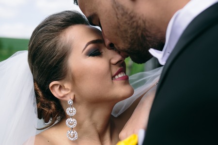 beautiful young wedding couple having fun outdoorsの写真素材