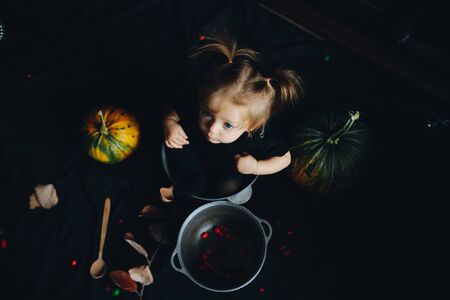 little girl playing in a witch on Halloweenの写真素材