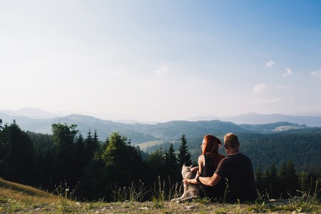 beautiful couple standing on a hill and looks into the distanceの写真素材