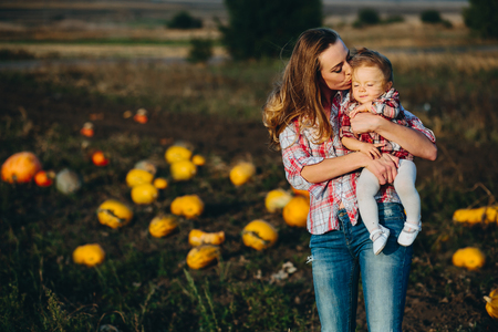 mother and daughter on a field with pumpkins, Halloween eveの写真素材