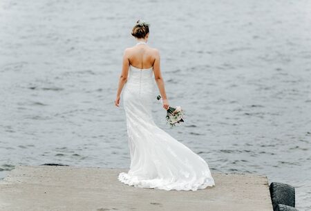 Bride posing on the pier at the lakeの写真素材