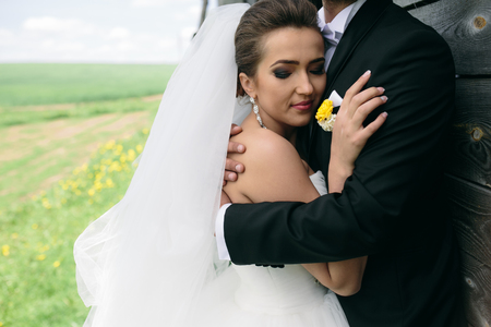 beautiful young wedding couple in each other's armsの写真素材