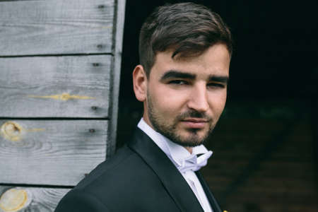 young handsome groom posing and looking at the cameraの写真素材