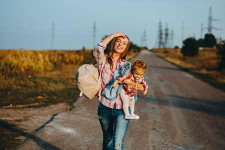 mother and daughter walking on the roadの写真素材