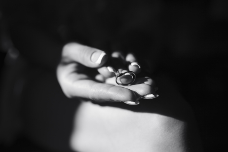 wedding rings lie in the hand of the brideの写真素材