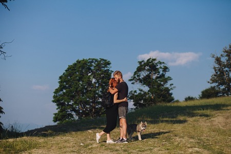 beautiful couple standing on a mountain and looking at each otherの写真素材