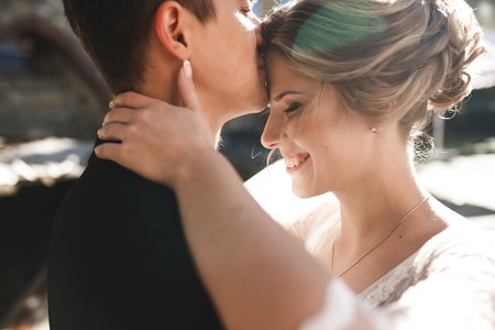 bride and groom posing on the streets of the old city, close to the angleの写真素材