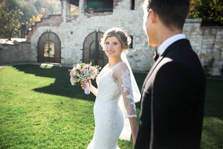 Bride and groom having fun in an old townの写真素材