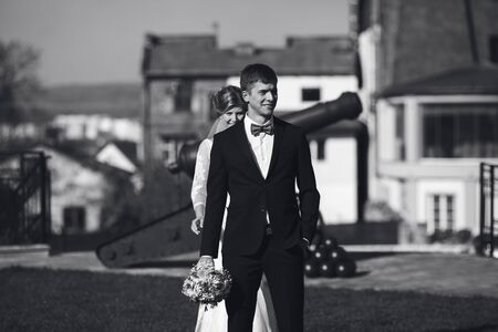 Bride goes from the back to the groomの写真素材