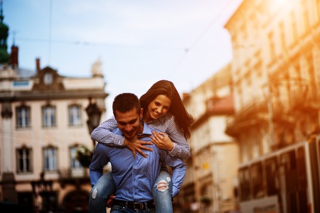 young beautiful couple walking and having fun in the cityの写真素材