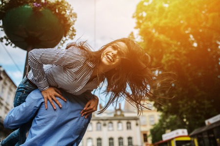 young beautiful couple walking and having fun in the cityの写真素材