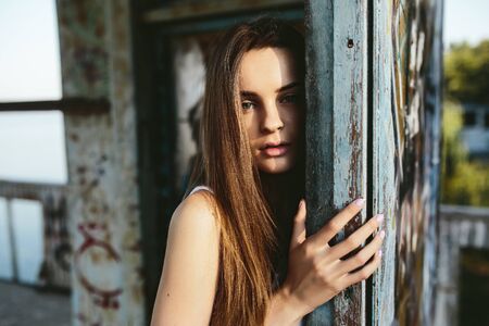 young beautiful girl posing in an abandoned buildingの写真素材