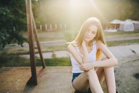 young beautiful girl posing while standing in an abandoned structureの写真素材