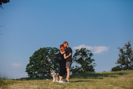 beautiful couple standing on a mountain and looking at each otherの写真素材