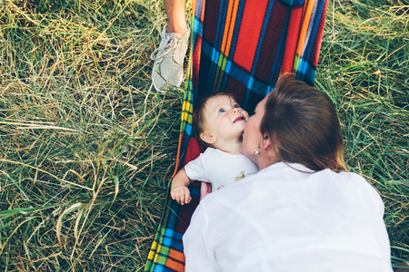 father, mother and little daughter having fun outdoors, playing together in summer parkの写真素材