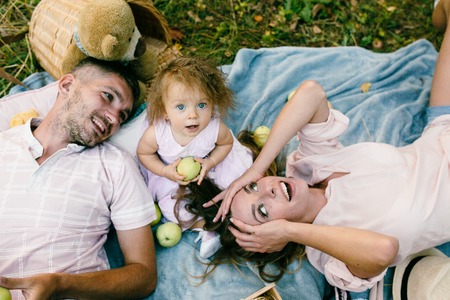 Happy family on the lawn in the parkの写真素材