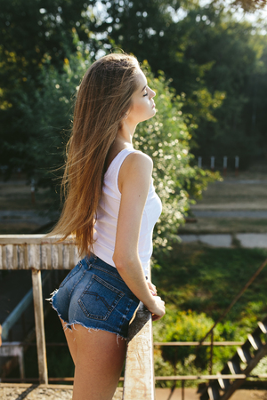 young beautiful girl posing while standing in an abandoned structureの写真素材
