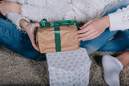 Two pretty girls posing for the camera with gifts for Christmas, close viewの写真素材