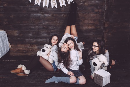 Four charming model posing on a vintage New Year's backgroundの写真素材