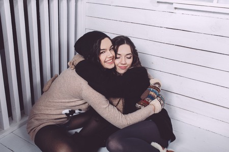 Cute girl embraced on the Christmas backgroundの写真素材