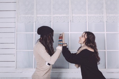 Cute girl embraced on the Christmas backgroundの写真素材