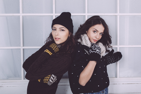 Cute girl embraced on the Christmas backgroundの写真素材