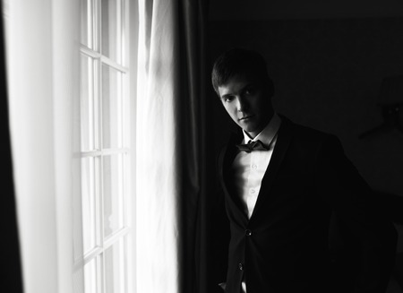 groom morning preparing for the wedding and posing for the cameraの写真素材