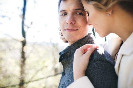 Bride hugs groom in a park close viewの写真素材