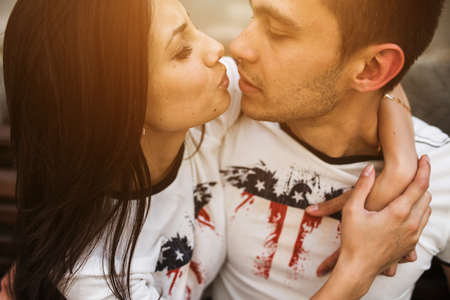 beautiful couple relaxing on a bench in the streetの写真素材