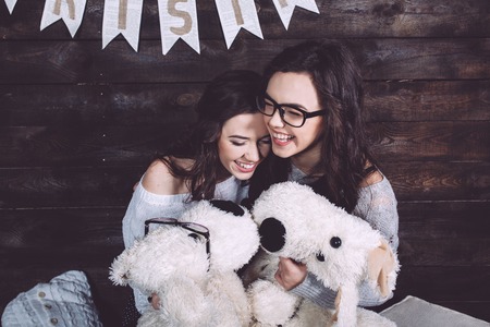 Two charming girls playing with Christmas toysの写真素材