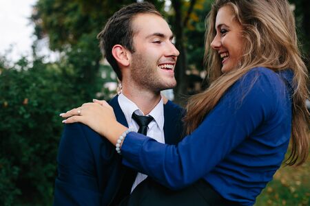 man holding his girlfriend in his arms in the park, close angleの写真素材