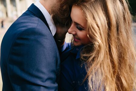beautiful couple in each other's arms posing in cityの写真素材