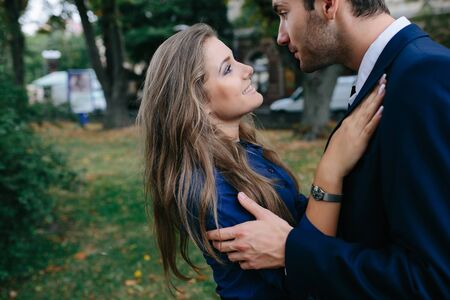 beautiful couple in each other's arms posing in cityの写真素材
