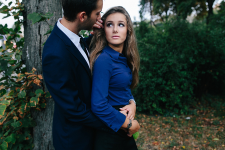 guy hugging his girlfriend from behind in the cityの写真素材