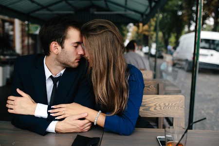 beautiful couple sitting in the cafe and having funの写真素材