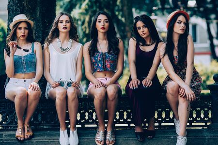 five beautiful young girls posing in the parkの写真素材