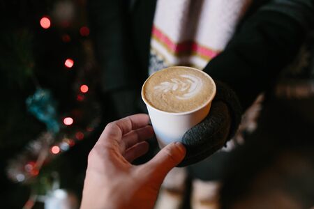 someone gives another person a cup of hot drink