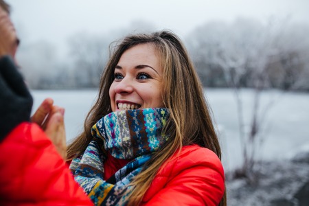 beautiful young couple staning and clapping in the parkの写真素材