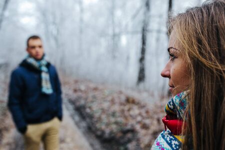 man and woman walking together on winter parkの写真素材