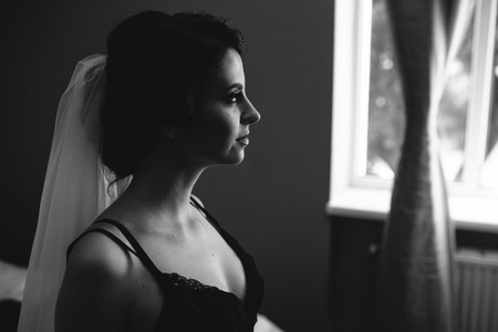 Bride sitting in a room and looking somewhereの写真素材