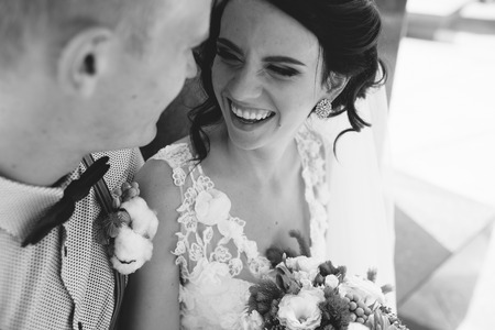 Wedding couple sitting on a stone bench, close viewの写真素材