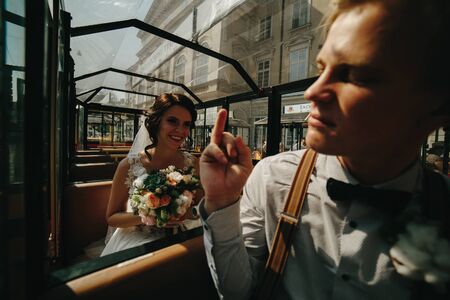 Bride and groom posing in the tour train and have funの写真素材