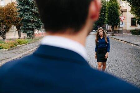 girl standing near the guy on the streetの写真素材