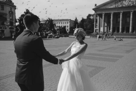 Young wedding couple walking and having funの写真素材