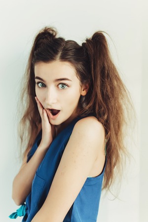 young beautiful girl posing on a white background