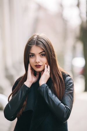 Young adult woman posing on a city streetの写真素材