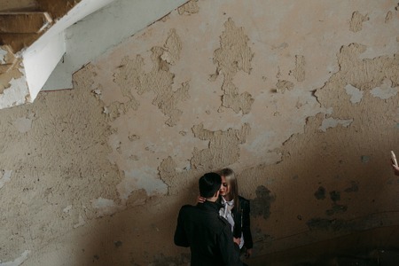 Photo of a young beautiful couple on the background of the old wallの写真素材
